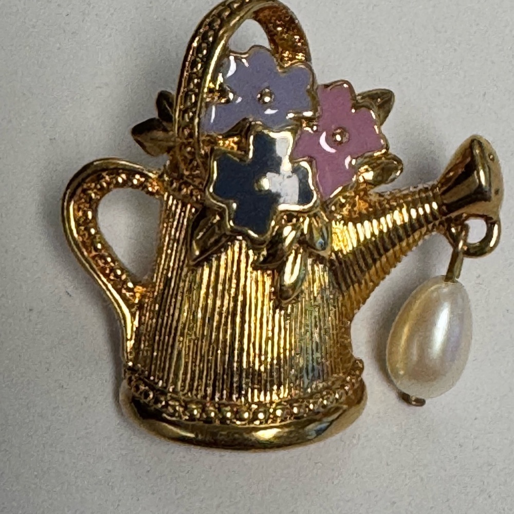 Vintage 1992 Avon "Friendship in Bloom" lapel pin. Gold tone watering can.